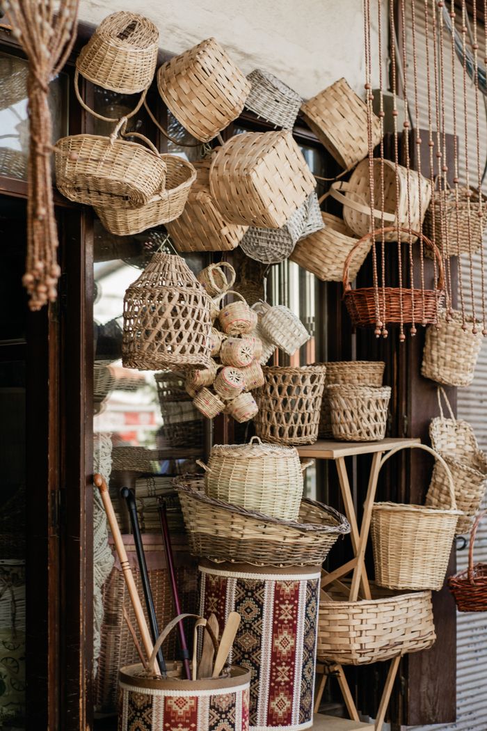 A variety of handcrafted straw baskets on display at a market stall.